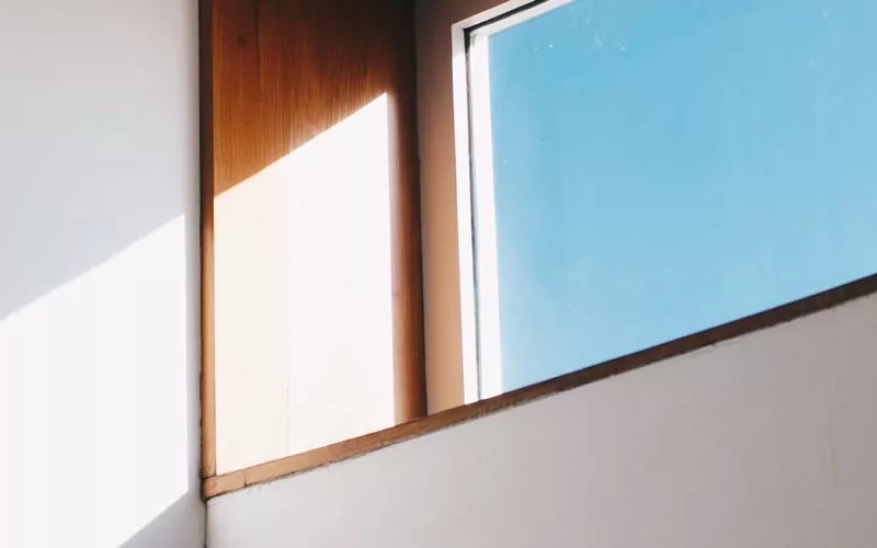 Fenster mit Holzrahmen und schräg einfallendem Licht